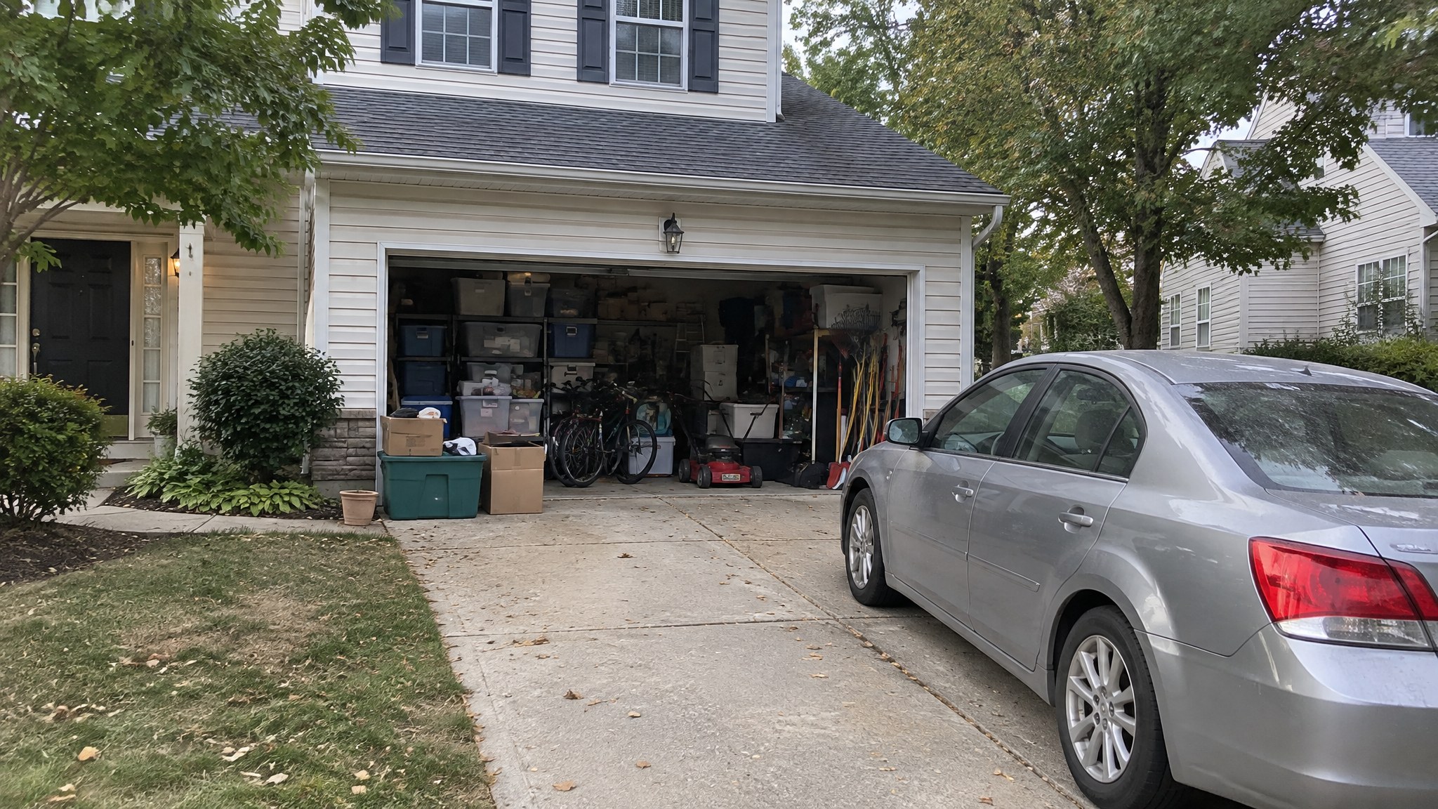 Cluttered garage before a Waterloo Structure shed in southeastern Pennsylvania